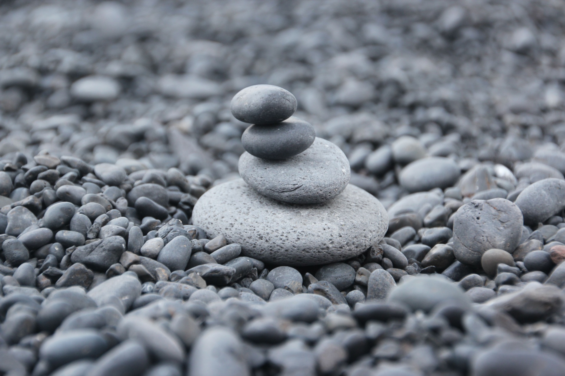 Stacked stones on an Icelandic black-pebble beach